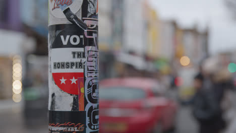 Close-Up-Of-Flyers-Stuck-Onto-Lampost-In-Camden-North-London-UK